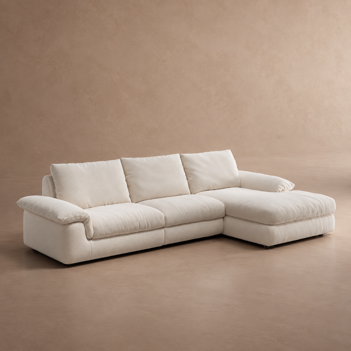Angled product view of a modern white L-shaped sectional sofa with a chaise